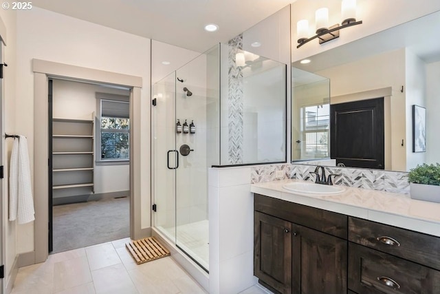 bathroom featuring vanity, tile patterned flooring, and walk in shower