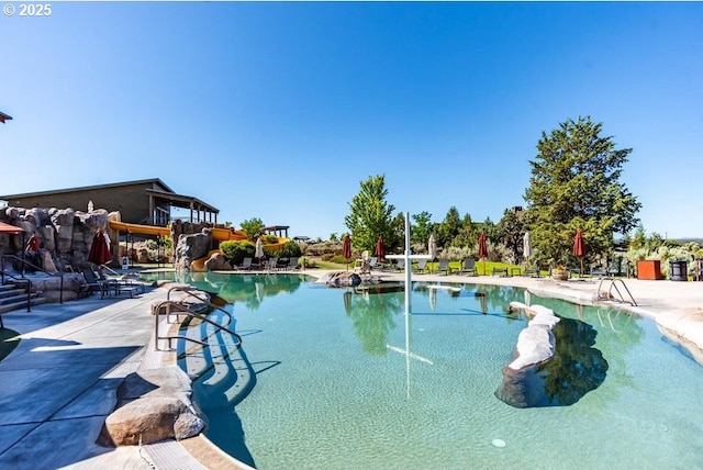 view of swimming pool featuring a patio area and a water slide