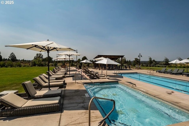 view of pool featuring a patio and a yard