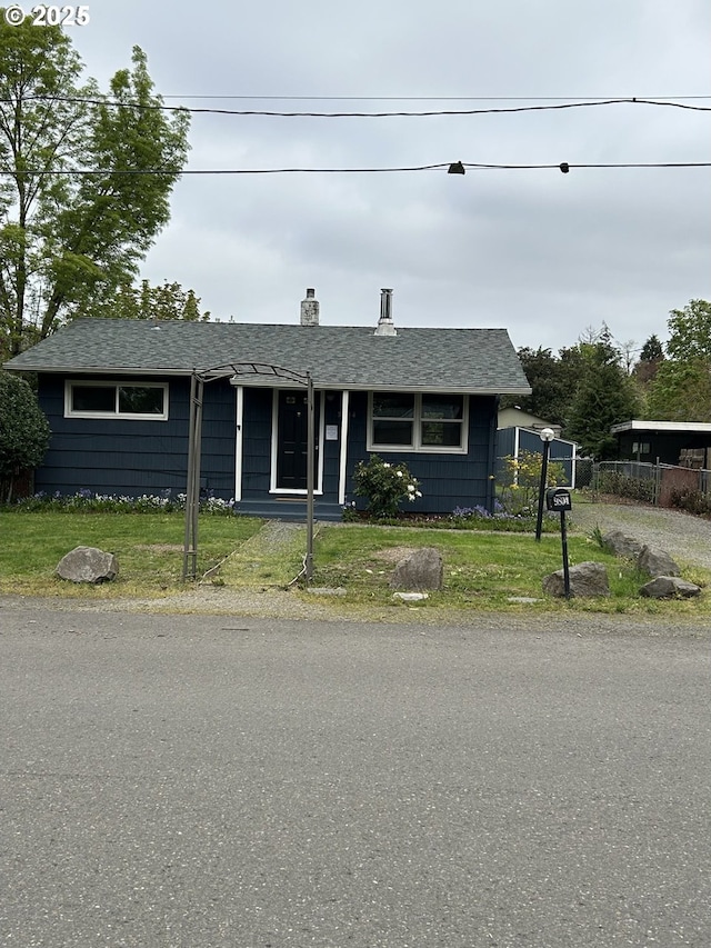 9804 NE 2nd St, Vancouver, WA 98664 - view of front facade featuring a chimney, fence, a shingled roof, and a front yard