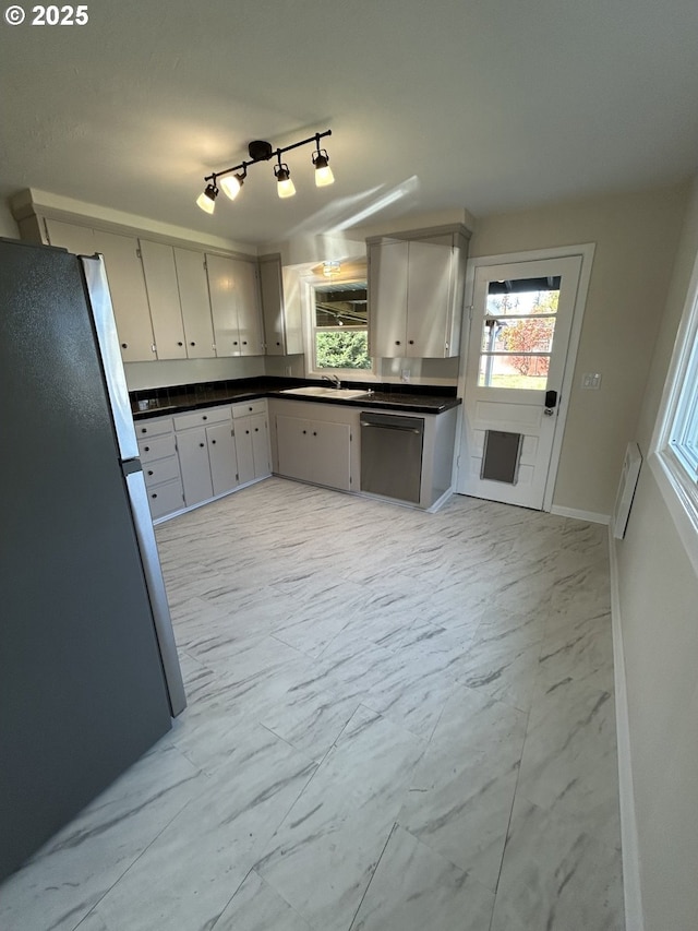 9804 NE 2nd St, Vancouver, WA 98664 - kitchen featuring appliances with stainless steel finishes, dark countertops, marble finish floor, and a sink