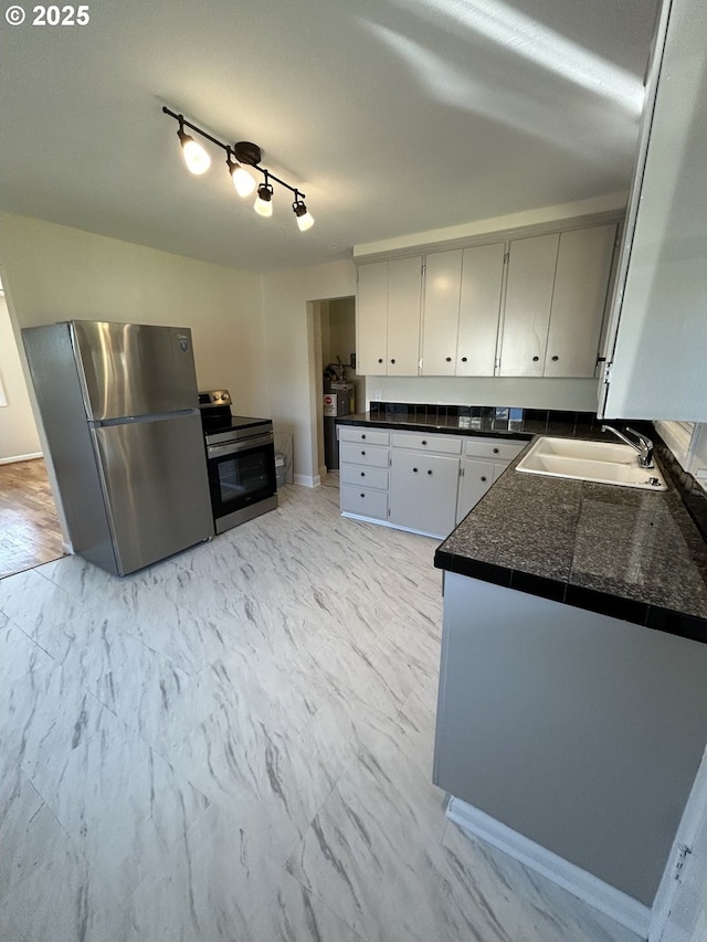 9804 NE 2nd St, Vancouver, WA 98664 - kitchen with dark countertops, appliances with stainless steel finishes, marble finish floor, and a sink