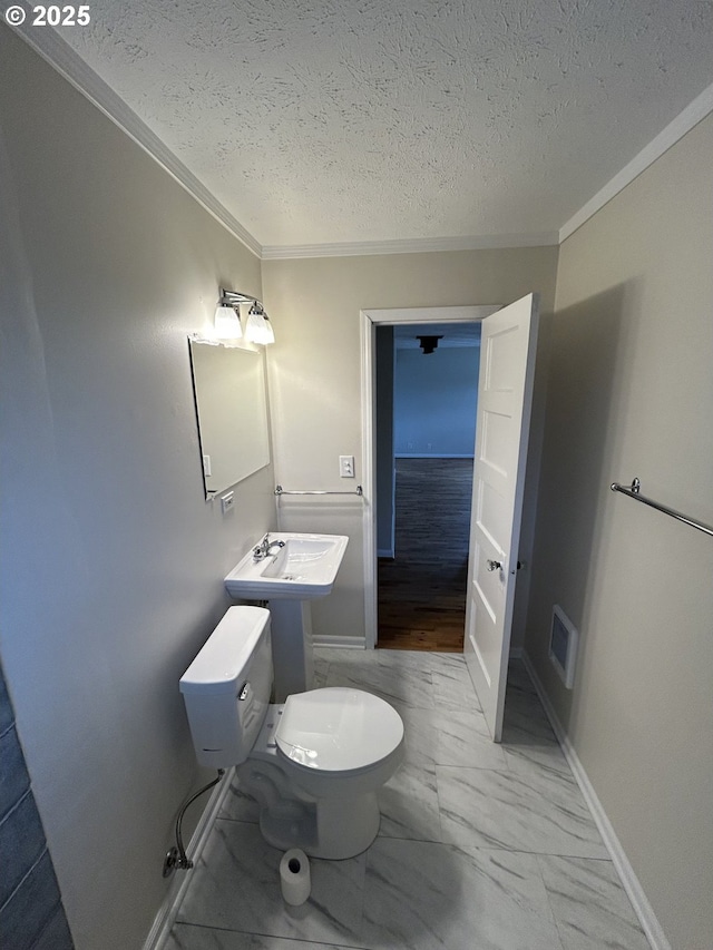 9804 NE 2nd St, Vancouver, WA 98664 - bathroom with marble finish floor, ornamental molding, toilet, a sink, and a textured ceiling