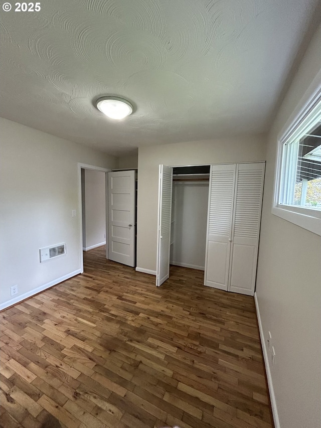 9804 NE 2nd St, Vancouver, WA 98664 - unfurnished bedroom with baseboards, visible vents, and wood finished floors