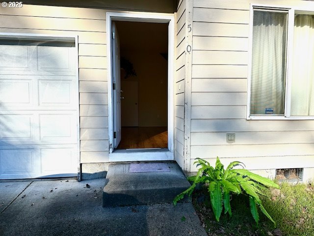 doorway to property with a garage