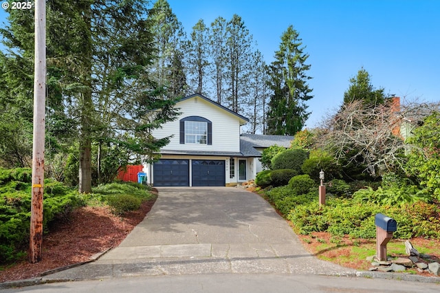 traditional-style house featuring an attached garage and driveway