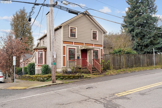 view of front of home with fence and a chimney