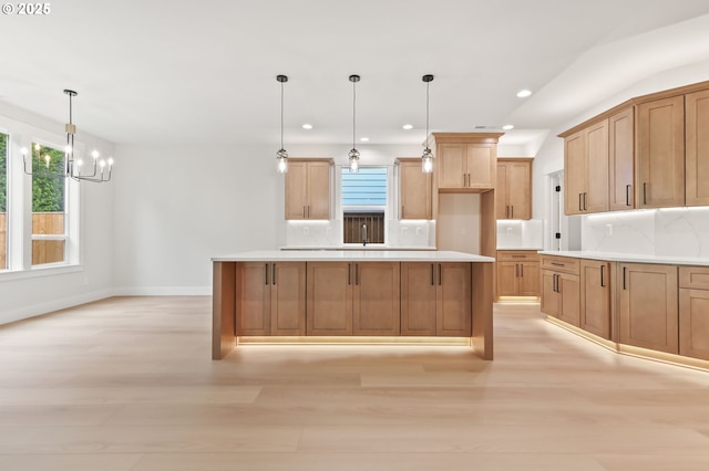 648 Parker Loop, Silverton, OR 97381 - kitchen with light wood finished floors, decorative backsplash, a chandelier, pendant lighting, and recessed lighting