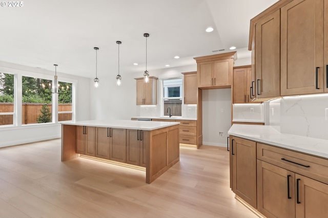648 Parker Loop, Silverton, OR 97381 - kitchen with a sink, light wood-style floors, tasteful backsplash, a kitchen island, and recessed lighting