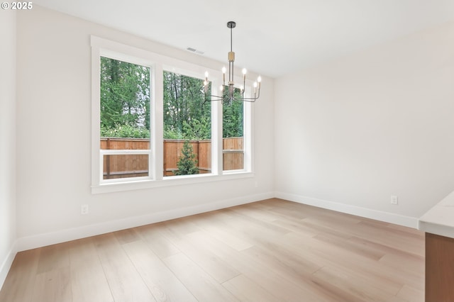 648 Parker Loop, Silverton, OR 97381 - unfurnished dining area featuring a chandelier, light wood finished floors, and baseboards