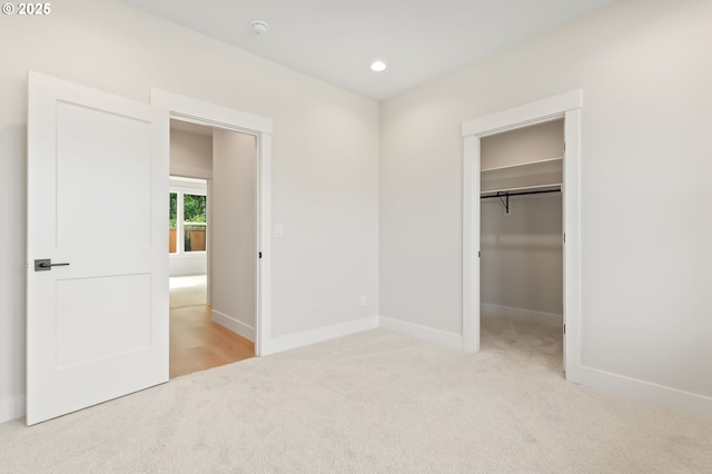 648 Parker Loop, Silverton, OR 97381 - unfurnished bedroom featuring light carpet, baseboards, a walk in closet, recessed lighting, and a closet