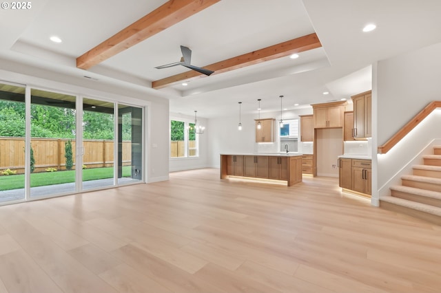 648 Parker Loop, Silverton, OR 97381 - unfurnished living room with recessed lighting, beamed ceiling, light wood finished floors, a sink, and baseboards