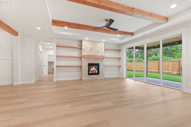 648 Parker Loop, Silverton, OR 97381 - unfurnished living room with light wood-style floors, beam ceiling, recessed lighting, baseboards, and a stone fireplace