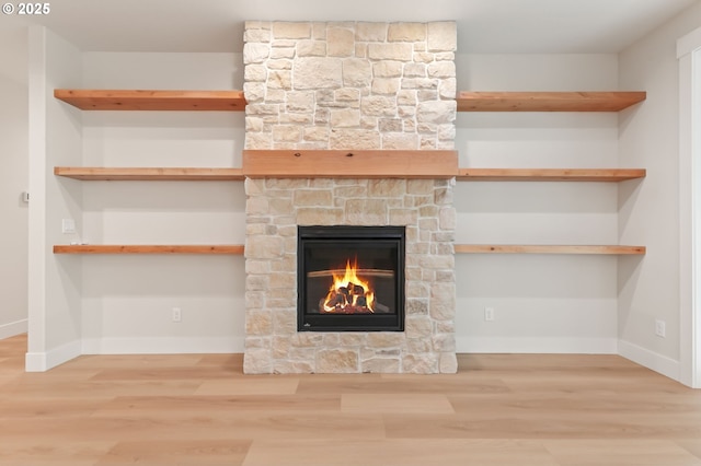 648 Parker Loop, Silverton, OR 97381 - detailed view of a stone fireplace, wood finished floors, and baseboards