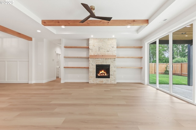648 Parker Loop, Silverton, OR 97381 - unfurnished living room with light wood-style flooring, recessed lighting, a stone fireplace, beam ceiling, and baseboards