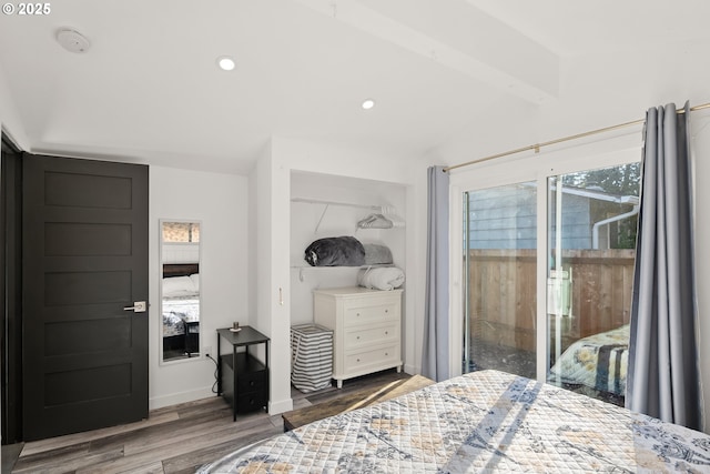 bedroom featuring dark wood-type flooring, access to outside, and lofted ceiling with beams