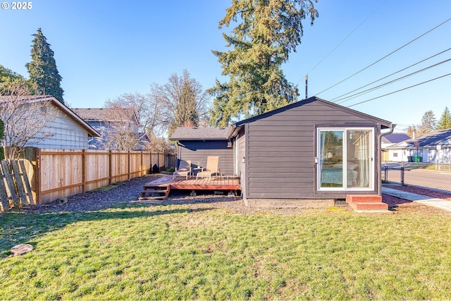 back of house featuring a yard and a deck