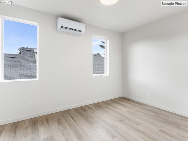 5866 N Missouri Ave Unit 4, Portland, OR 97206 - spare room featuring a wall mounted AC, light wood-style floors, and baseboards