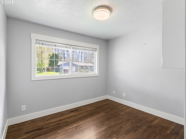 13145 SW 61st Ave, Portland, OR 97219 - spare room featuring dark wood-style flooring, baseboards, and a textured ceiling