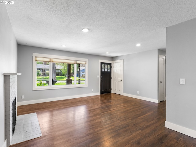13145 SW 61st Ave, Portland, OR 97219 - unfurnished living room with a brick fireplace, wood finished floors, recessed lighting, baseboards, and a textured ceiling
