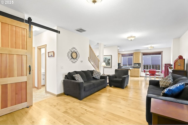 403 W Oxford St, Newberg, OR 97132 - living area with a barn door, light wood finished floors, and stairs