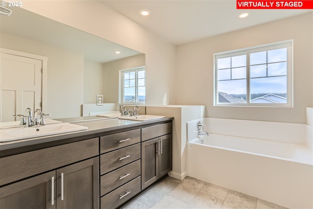 bathroom featuring a tub to relax in and vanity