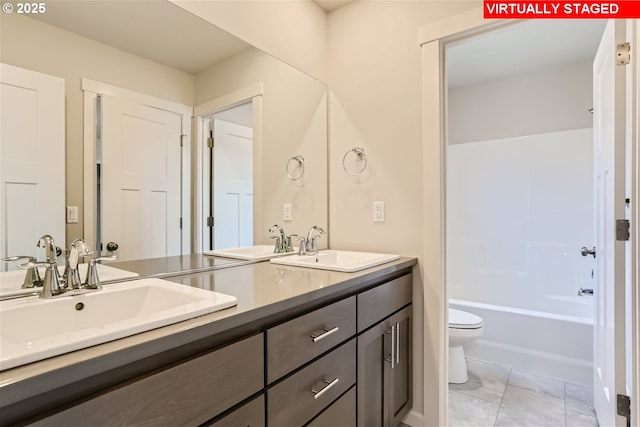 full bathroom with toilet, vanity,  shower combination, and tile patterned flooring