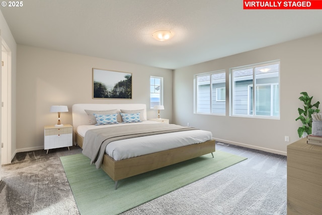 carpeted bedroom with visible vents and baseboards