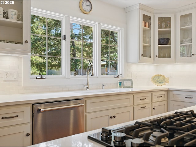 652 Nita Ave, Gearhart, OR 97138 - kitchen featuring stainless steel appliances, a sink, light countertops, tasteful backsplash, and glass insert cabinets