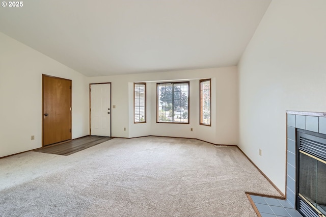 21122 NW Cannes Dr, Portland, OR 97229 - unfurnished living room with carpet, vaulted ceiling, and a fireplace