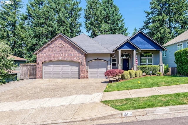 15110 Oyer Dr, Oregon City, OR 97045 - view of front of home featuring a garage, driveway, and brick siding