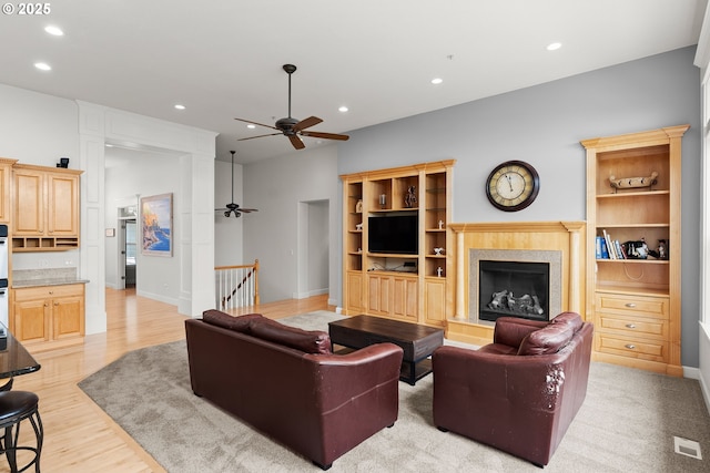 15110 Oyer Dr, Oregon City, OR 97045 - living area featuring a ceiling fan, recessed lighting, a fireplace with raised hearth, and light wood-style floors