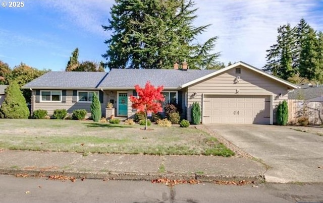 single story home with a garage, driveway, and a front lawn