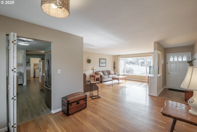 entrance foyer featuring baseboards and wood finished floors