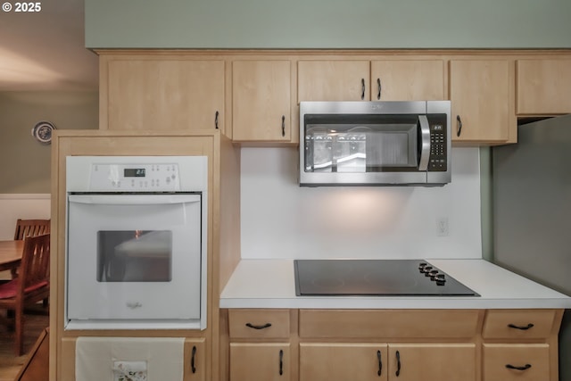 kitchen with stainless steel appliances, light countertops, and light brown cabinets