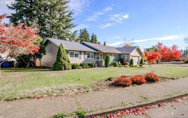 ranch-style house with an attached garage and a front yard