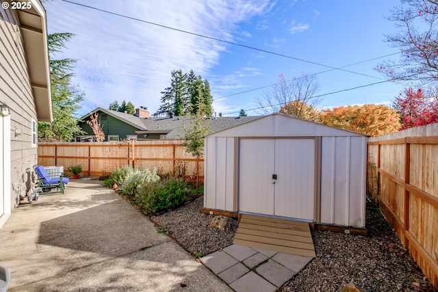 view of shed with a fenced backyard