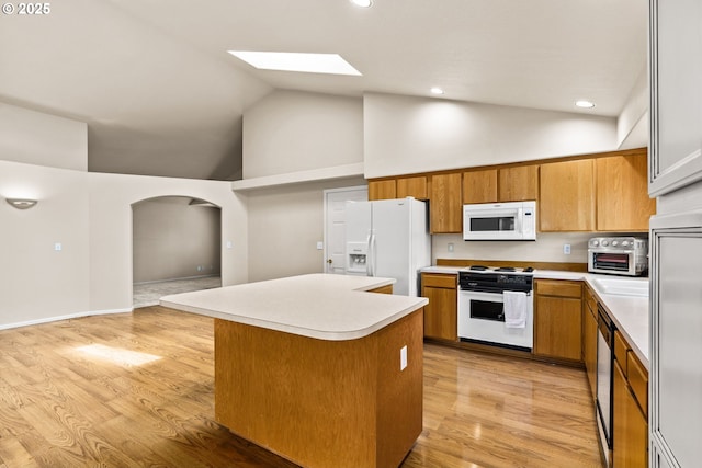 2494 Cubit St, Eugene, OR 97402 - kitchen with white appliances, light countertops, a kitchen island, high vaulted ceiling, and brown cabinetry