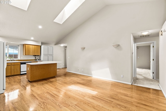 2494 Cubit St, Eugene, OR 97402 - kitchen with white appliances, a skylight, high vaulted ceiling, a kitchen island, and light countertops