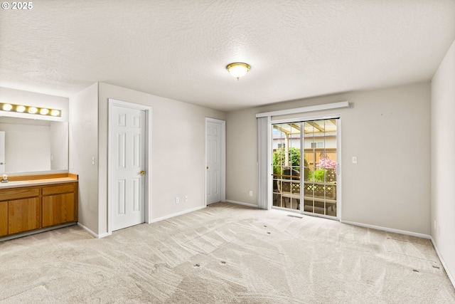 2494 Cubit St, Eugene, OR 97402 - unfurnished bedroom featuring access to exterior, baseboards, light carpet, and a textured ceiling