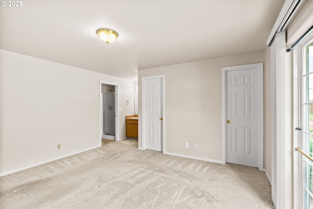 2494 Cubit St, Eugene, OR 97402 - unfurnished bedroom featuring light carpet, baseboards, and ensuite bath
