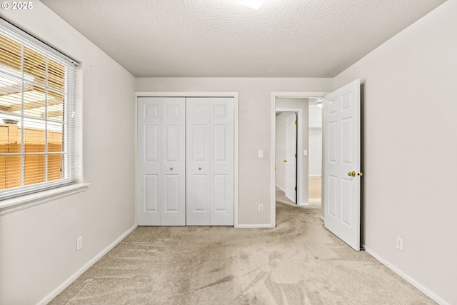 2494 Cubit St, Eugene, OR 97402 - unfurnished bedroom with carpet flooring, a closet, baseboards, and a textured ceiling