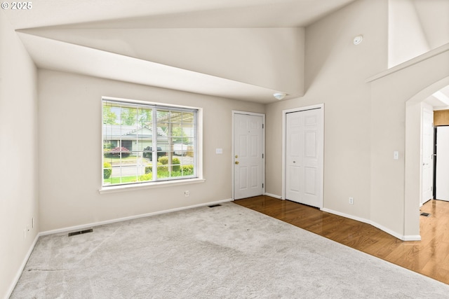 2494 Cubit St, Eugene, OR 97402 - carpeted foyer entrance with arched walkways, baseboards, and high vaulted ceiling