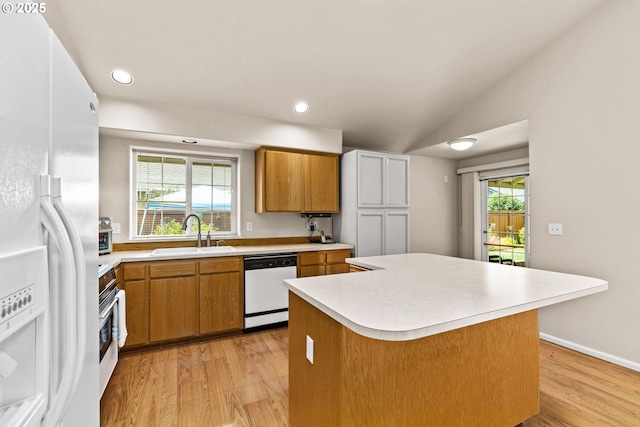 2494 Cubit St, Eugene, OR 97402 - kitchen featuring white appliances, a sink, light countertops, brown cabinetry, and lofted ceiling