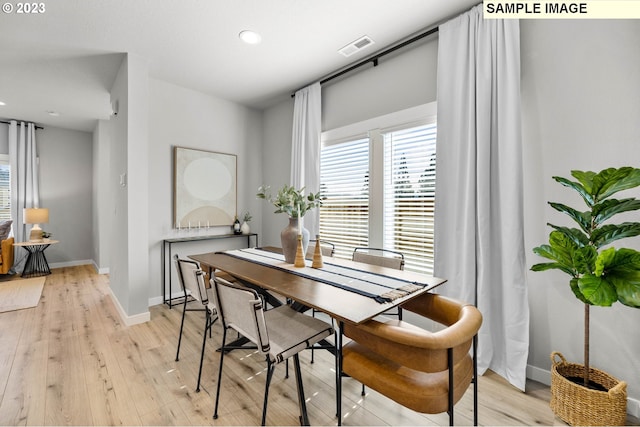 dining area with plenty of natural light, light wood finished floors, baseboards, and recessed lighting