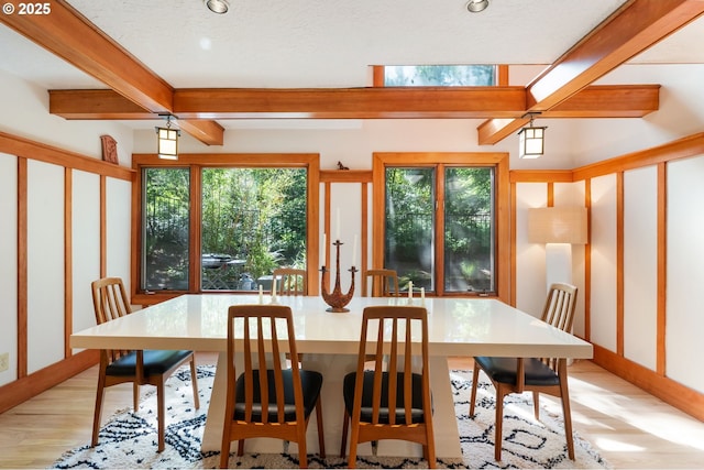 dining room featuring light wood-style floors, recessed lighting, and beam ceiling