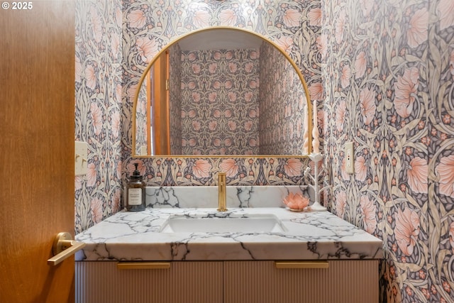 bathroom featuring wallpapered walls and vanity