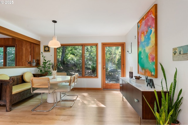 dining area featuring light wood-style floors and baseboards