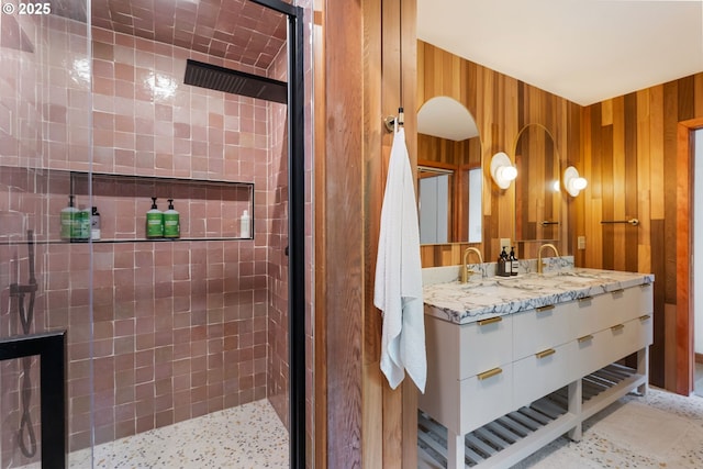 full bathroom with tiled shower and vanity