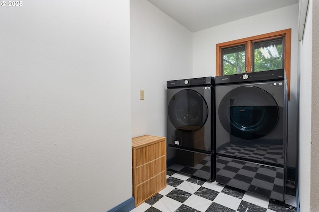 clothes washing area featuring separate washer and dryer, laundry area, and tile patterned floors
